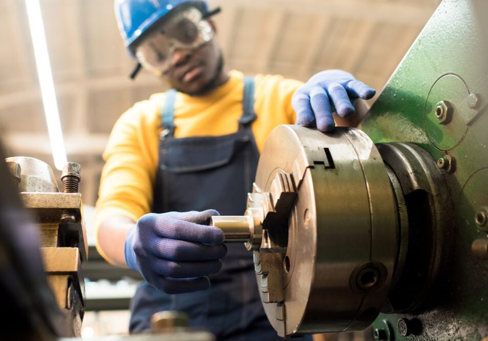 Confident,African,American,Machine,Operator,Wearing,Safety,Goggles,And,Hardhat